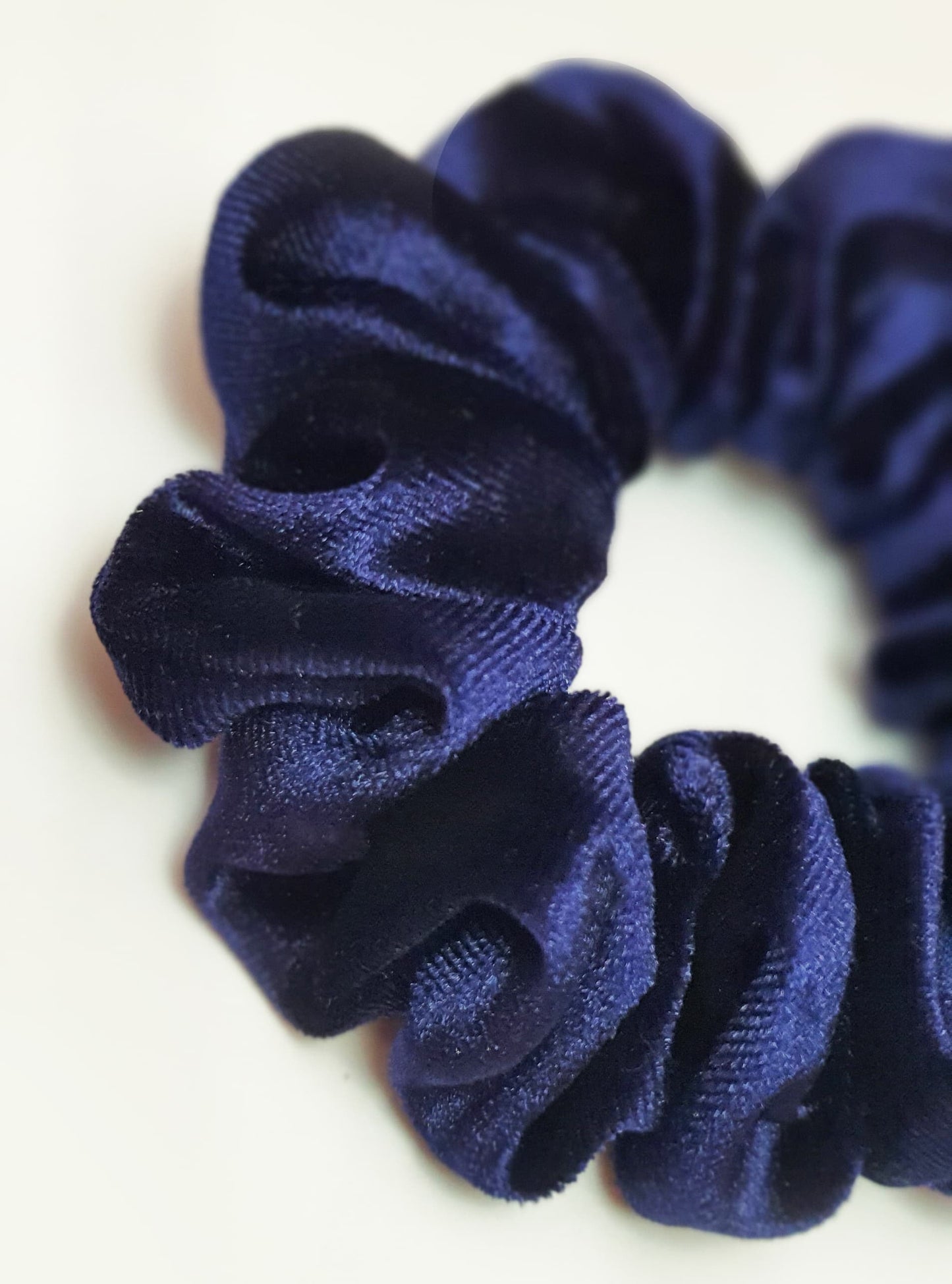High-quality blue velvet scrunchie featuring a soft, plush fabric that provides a comfortable and fashionable hair accessory option