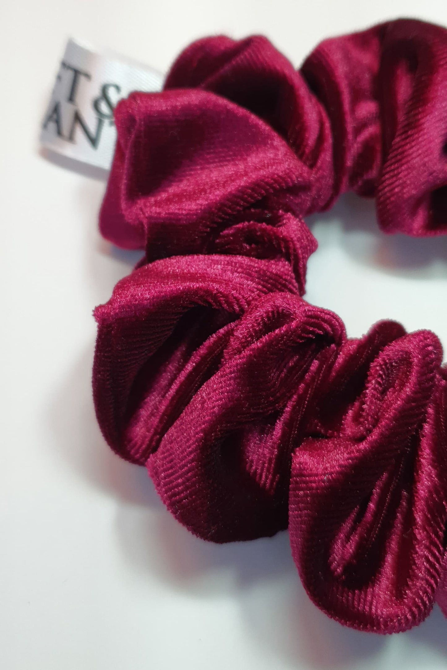 A close-up of the Softandelegant red Velvet Scrunchie, showcasing its soft texture and vibrant red shade, perfect for elegant hairstyles.