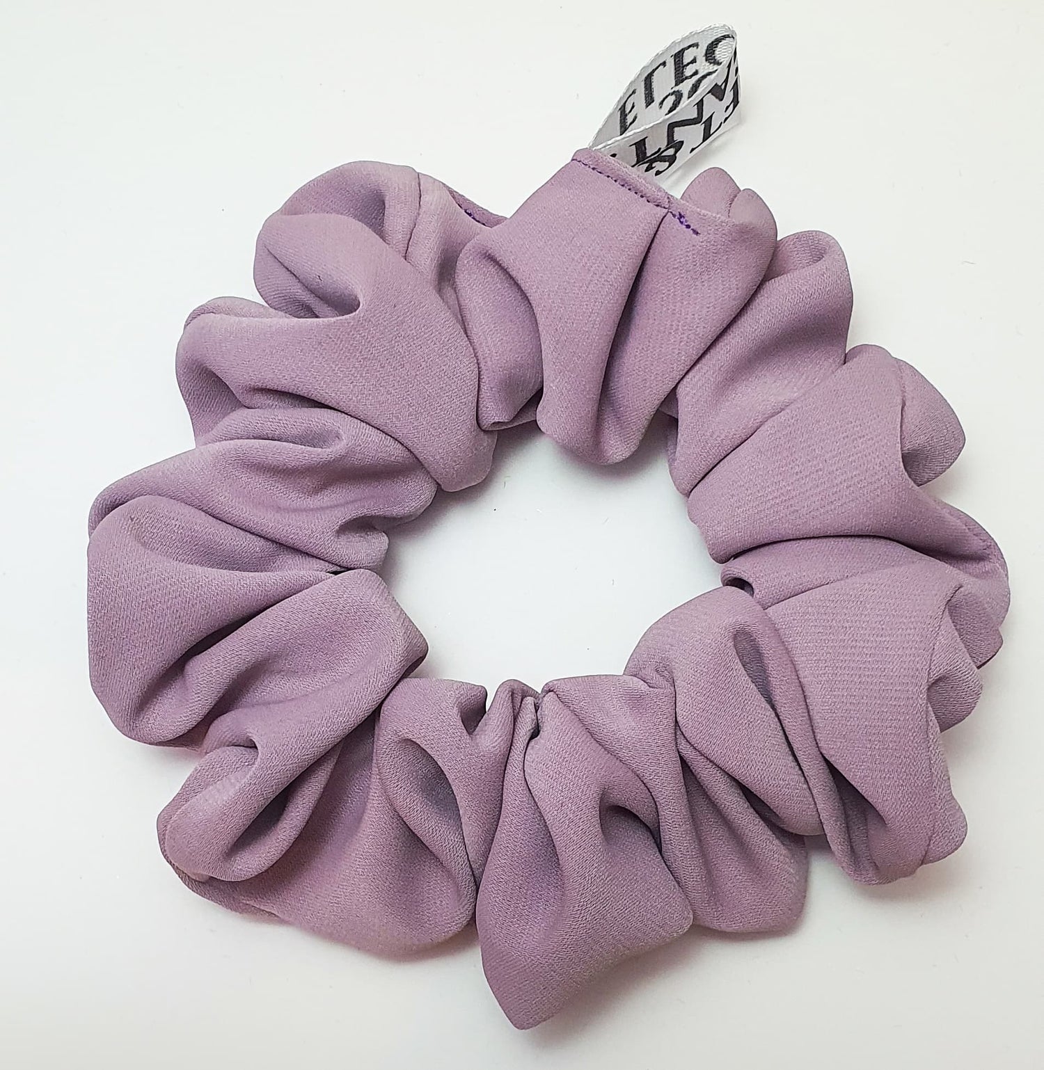 Soft lavender pink crepe scrunchie with a lightweight, gentle hold for hair.